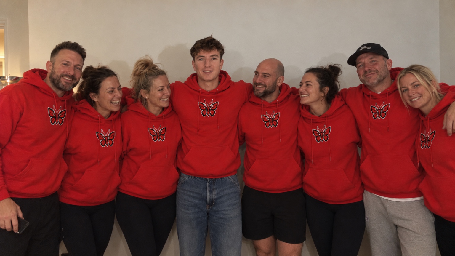 Reece and a group wearing red Gazelle Boxing hoodies